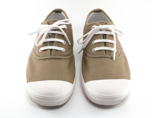 pair of brown sneaker canvas shoes with tied string isolated on white