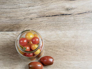 Cherry tomatoes background in a glass jar