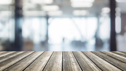 Wood table top and blurred bokeh office interior space background - can used for display or montage your products.