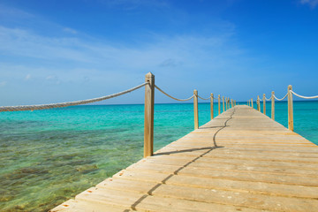 Obraz premium Wooden bridge over the sea. Travel and Vacation. Freedom Concept.