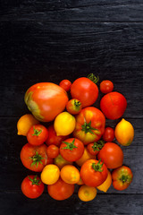 Tomatoes from a home garden on a black board background