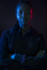 Dark colorful portrait of confident african woman with dark skin