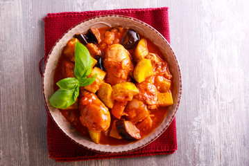 Chicken drumsticks and vegetable stew in a bowl