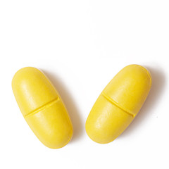 Yellow pills on white