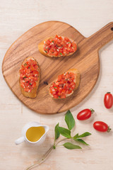 Appetizer bruschetta with tomatoes, olives and herbs. Italian cuisine