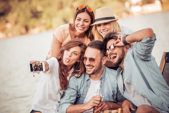 Group Of Friends Taking Selfie On The Beach