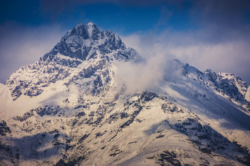 A view of mount cook peak in autumn, south island, New Zealand covered in snow contrast with blue sky.