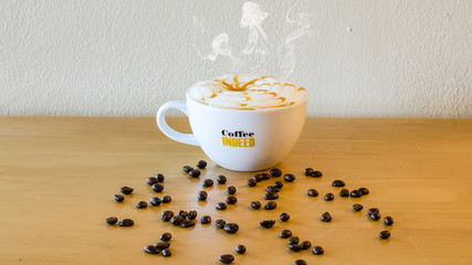 Coffee cup and saucer on a wooden table. Grey background,beverage,tasty