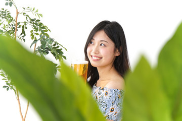 Young woman drinking beer outside