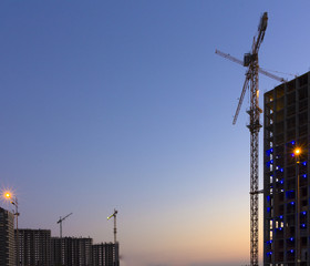 Naklejka premium Construction of high-rise building tower crane