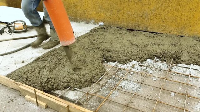 Builder is pouring the concrete