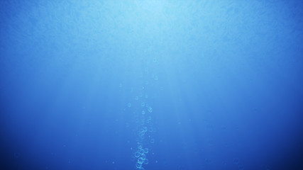 Obraz premium Blue ocean waves from underwater with bubbles. Light beam rays shining through.