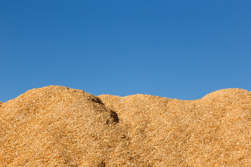 Mountain of sawdust Against the blue sky