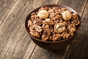 Walnuts in a bowl on wooden table