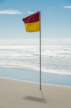 Red And Yellow Beach Patrol Flag On The Gold Coast.