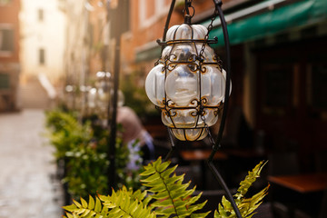 Lantern in a street cafe at dawn