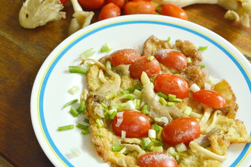 egg omelet stuffed Indian mushroom topping slice cherry tomato on plate