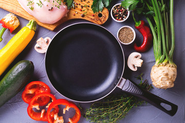 Raw chicken breast fillets with various vegetables ingredients