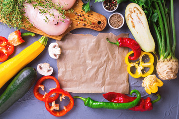 Raw chicken breast fillets with various vegetables ingredients