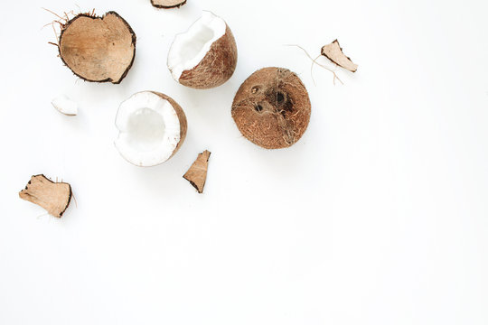 Cracked coconut on white background. Flat lat, top view