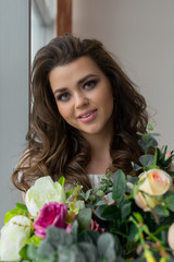 Attractive woman with fresh bouquet of roses