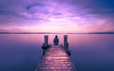 Schilderijen op glas Mystical world. A lone figure on the pier of the lake. Long exposure. © patma145