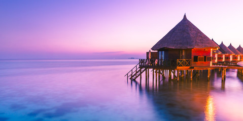 Water bungalow. Sunset on the islands of the Maldives. A place for dreams. - obrazy, fototapety, plakaty