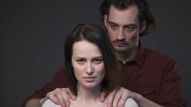 Domestic violence, man's hands keeping woman's shoulders, zoom in