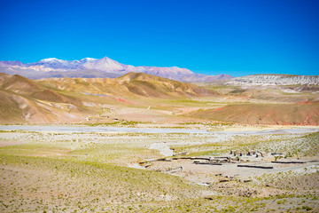 High altitude barren mountain range on the highlands of the Andes on the way to the famous Uyuni Salt Flat, among the most important travel destination in Bolivia. Abandoned old village in the plateau