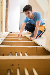 Apprentice Plumber Fitting Central Heating System In House