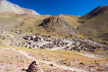 High altitude barren mountain range on the highlands of the Andes on the way to the famous Uyuni Salt Flat, among the most important travel destination in Bolivia. Abandoned old village in the plateau