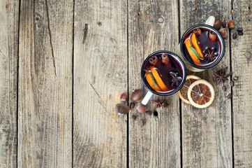 Mulled wine in iron circles on a wooden background