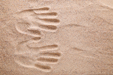 Handprints on the beach sand