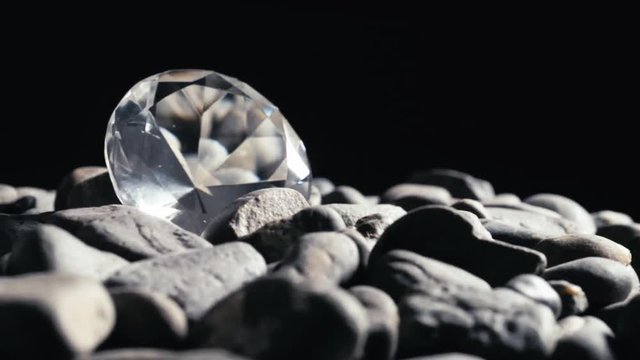 fake diamond among pebbles. Seamless Looping,