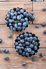 Ripe and tasty blueberries on brown wooden table