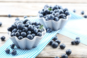 Ripe and tasty blueberries on grey wooden table