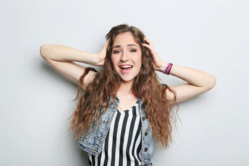 Fototapeta premium Portrait of young woman on grey background