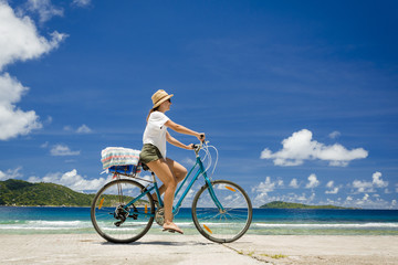 Obraz na płótnie Canvas Woman ride along The Beach
