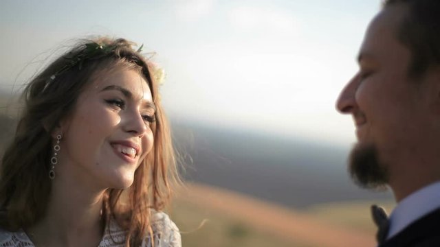 beautiful young couple on the background meadows