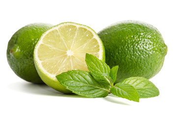 green mint, two limes with half of a juicy lime isolated on white background