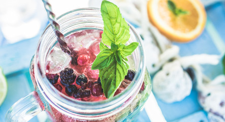 Top view of berries mojito on blue wood bar counter - Latin, summer, cocktails, drinks, party, and people concept - Main on bottom soft fruit - Vintage retro filter
