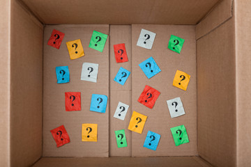 Question marks inside of a cardboard box