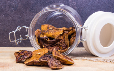 Dried forest mushrooms on a wooden table.