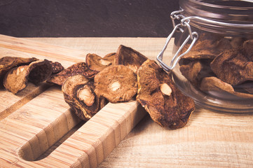 Dried forest mushrooms on a wooden table.