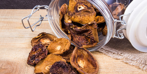 Dried forest mushrooms on a wooden table.