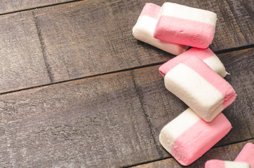 Pink marshmallows on a dark background with copyspace