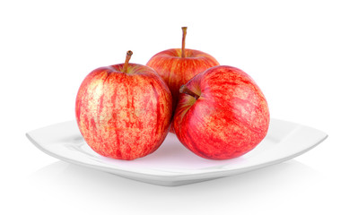 red apple in white plate on white background