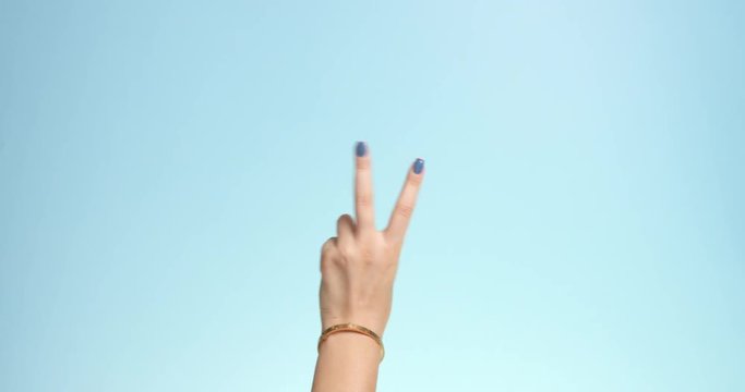 woman's hand making a count down on a bright blue background