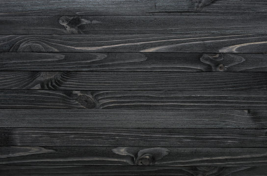 Dark Black Wood Texture Background Viewed From Above. The Wooden Planks Are Stacked Horizontally