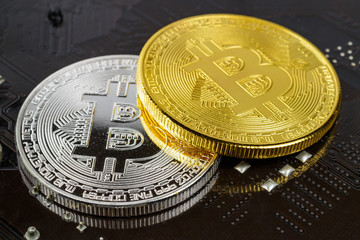 Silver and golden bitcoins on the black background closeup. Cryptocurrency virtual money